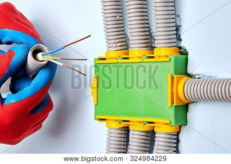 An Electrician Is Wires An Electrical Junction Box. A Junction Box Is Used To Add A Spur Or To Exten