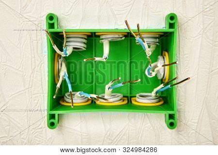Installation Of A Wall-mounted Electrical Junction Box For The Home Electrical System, Green Square 