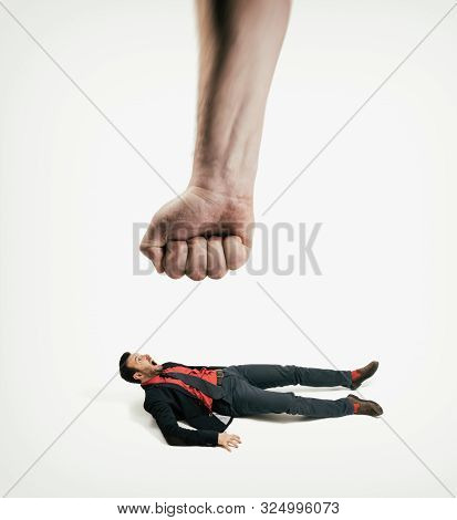The Big Human Fist Bring Down The Man Off His Feet. Concept Of Unexpected Problems Which Gets Knocke