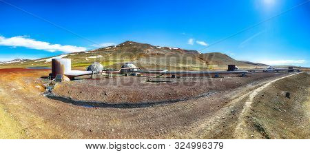 Icelandic Landscape With Geothermal Power Plant Station And Pipes. Borehole Well Of Krafla Power Sta