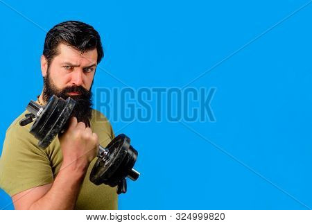 Bearded Man With Dumbbell During Exercise. Muscular Fitness Model Raising Dumbbell. Man With Dumbbel