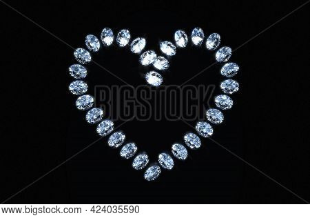 A Close Up View Of An Array Of Cut Diamonds In The Shape Of A Heart On A Black Isolated Background -