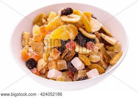A Mixture Of Chopped Dried Fruits And Berries, Nuts In A White Dish On A White Background . Isolated