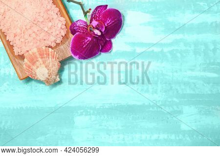 Wooden Bowl With Pink Sea Salt With Seashell And Purple Orchid. Beauty And Spa. Turquoise Background