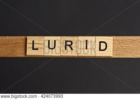 Text On Word Lurid From Gray Wooden Letters On A Black Background