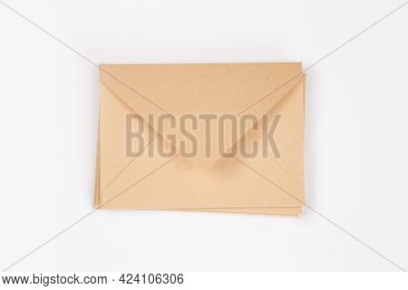 Stack Of Light Brown Paper Open Envelope On White Isolated Background. Three Craft Envelopes For Inv
