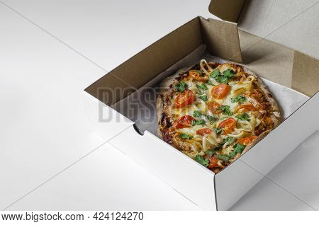 Pinsa In A Cardboard Box Close-up. Pinsa, Pizza Delivery Concept. Pinsa Home Cooking.