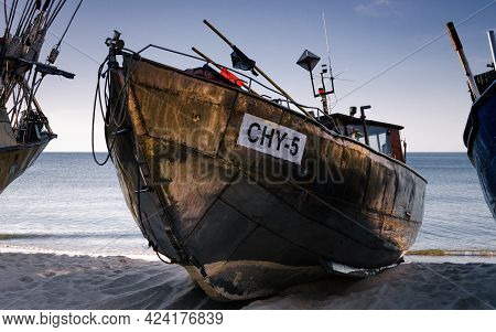 Chlopy, West Pomeranian - Poland - 2021: Fishing Boats Pulled Onto The Sea Shore