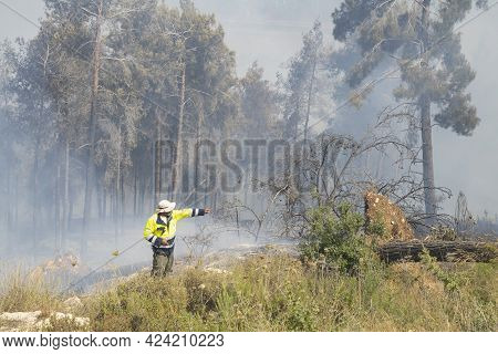 Mevasseret Zion, Israel - June 19th, 2021: A Fire Fighter During A Pine Forest Fire On The Municipal