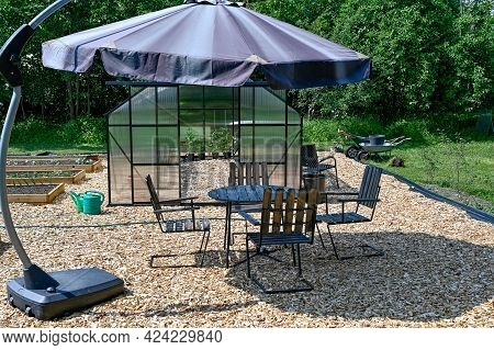 Greenhouse Table And Chairs With Sunshade In Garden