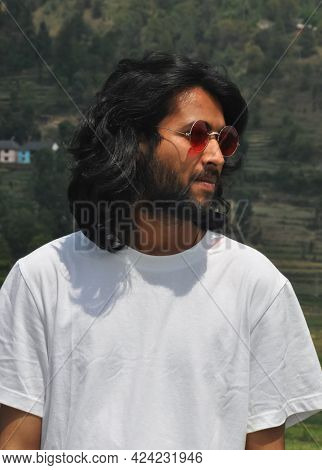 Portrait Shot Of A Handsome Long Haired Indian Young Men Wearing Sunglasses With Looking Sideways, A