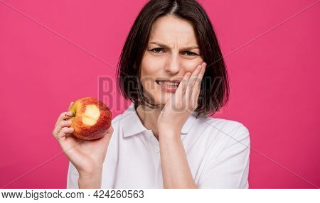 Beautiful Young Woman Bites A Big Apple And Has A Toothache