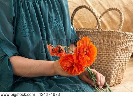 Woman In Green Dress Holding Poppe Flowers, Close Up On Her Hands. Spring Time Dreams.