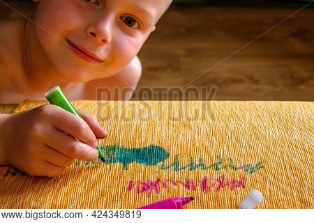 The Boy Drawing With Green Felt-tip Pens On The Fabric Of The Couch. Daily Life Dirty Stain For Wash