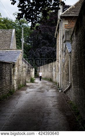 Corsham, Uk - July 17: A Person Walks In A Street In Corsham, An Old Village In South Of England On 