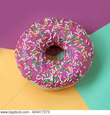 Pink Sweet Donut With Icing On Coloful Background Close-up, Top View.