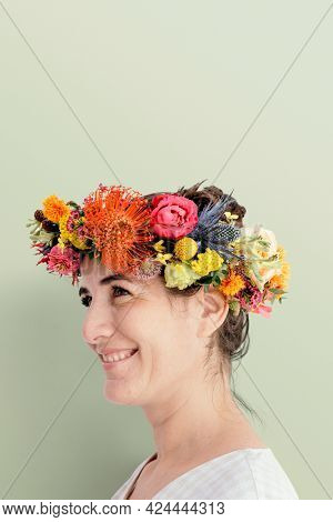 Beautiful woman with a midsummer floral wreath