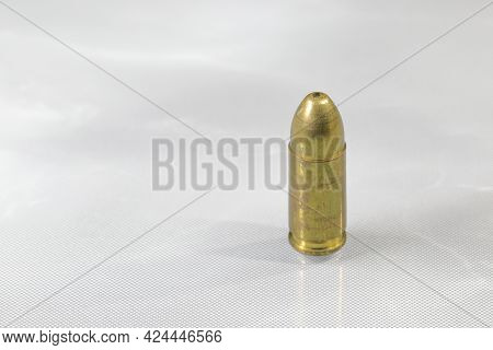 Close Up Bullet 9mm Parabellum Fmj (full Metal Jacket ) On Reflection Surface.