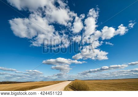 Landscape With Blue Sky Background And Big White Tiny Stratus Cirrus Striped Clouds