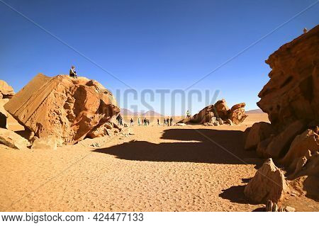 Group Of Travelers Visiting Group Of Amazing Rock Formations In Eduardo Avaroa Andean Fauna National