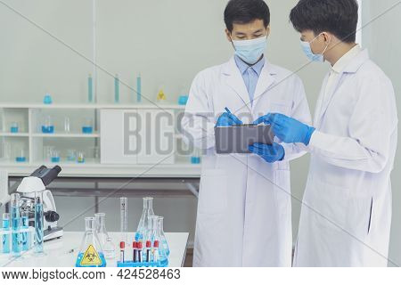 Two Asian Scientist Team Reserch Chemistry Science Tube Experiment Biotech Antibody Sample In Labora