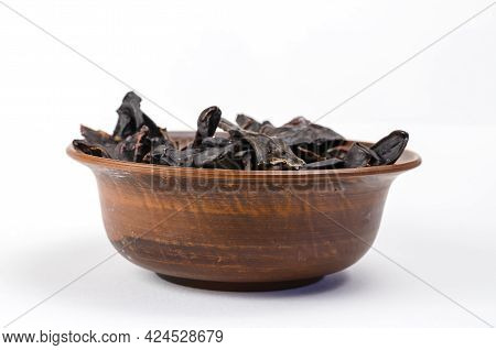 Dried Dog Treats In A Brown Clay Bowl On A White Background. Thin Slices Of Dehydrated Beef Kidneys.