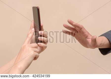 Do Not Shoot Concept. No Photo. One Person With Smartphone Photo Camera In Hand And Stop Gesture By 