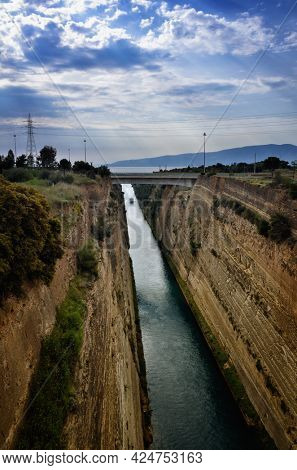 The Corinth Canal connects the Gulf of Corinth with the Saronic Gulf in the Aegean Sea in Greece. It cuts through the narrow Isthmus of Corinth and separates the Peloponnese from the Greek mainland