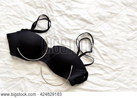 Black Bra And Stainless Steel Bra Wire On Fabric Background. Photo Can Be Used For Pros And Cons Of 