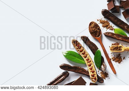 Carob Bean And Powder Flat Lay On Grey Background, Top View, Copy Space