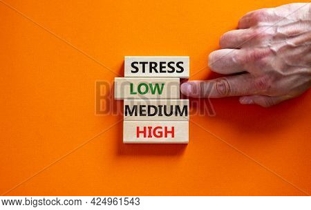 Low Or High Stress Level Symbol. Businessman Chooses The Wooden Block With Words Low Stress. Words S