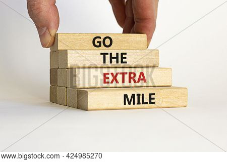 Go The Extra Mile Symbol. Wooden Blocks With Words 'go The Extra Mile'. Businessman Hand. Beautiful 