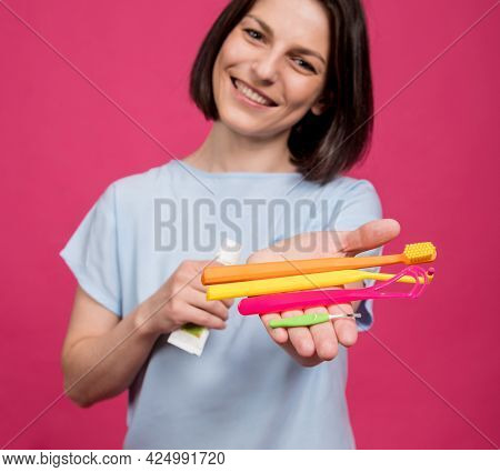 Beautiful Young Woman Uses An Oral Care Kit Consisting Of A Tongue Scraper, Single Tufted And Interd