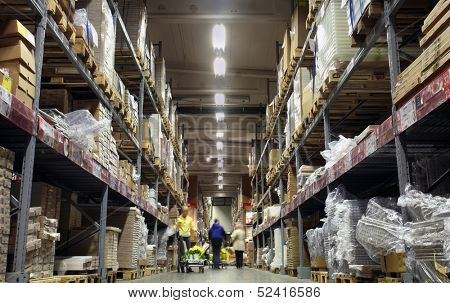 Photo of a corridor of shelves in a warehouse