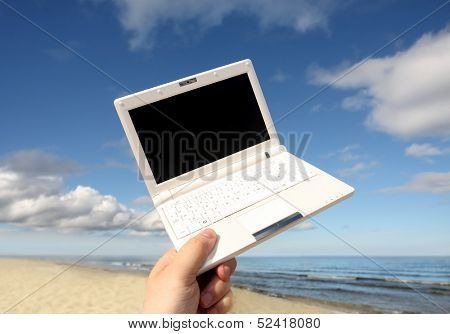 White small  Laptop on the beach