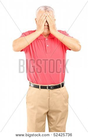 Mature man with hands over his eyes isolated on white background