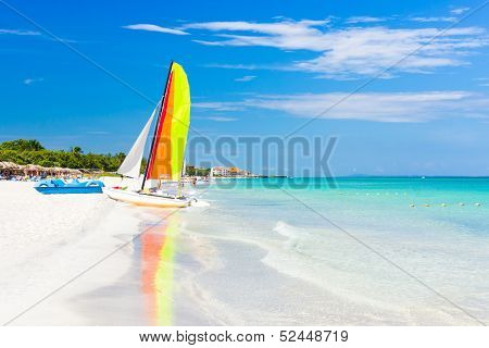 Scene with sailing boat at the famous Varadero beach , Caribbean sea in Cuba