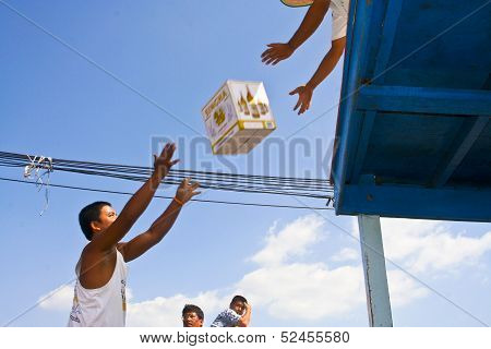 Man Is Loading The Ferry By Throwing Goods