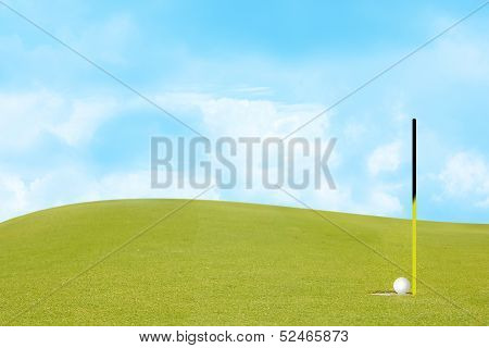 golf on green Include slope and sky.