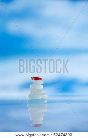 sea glass seaglass pile pyramid with reflection and seascape, shallow dof