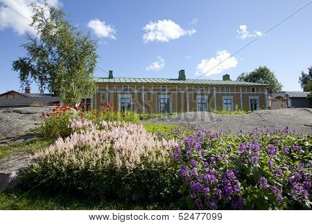 Flowers and elderly wooden buildings.