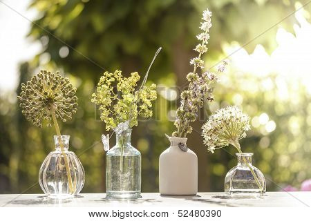 4 pots with flowers in them