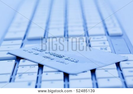 close-up a credit card for cashless payment and keyboard. photo icon for shopping on the internet.