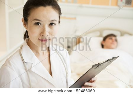 Portrait of smiling doctor holding a medical chart 