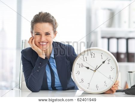 Happy Business Woman Showing Clock