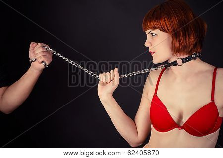 woman in the role of a slave on a leash