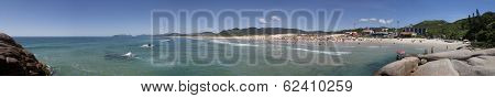 Florianopolis, Santa Catarina, Brazil - January 18, 2010: Panoramic view of Joaquina beach with many tourists enjoying the clear sky and sunny day on it.