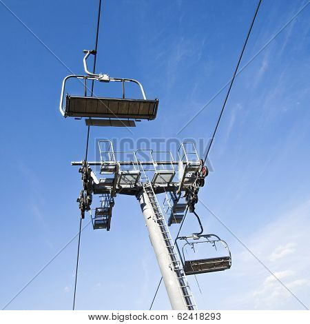 Chairlift in a blue sky background