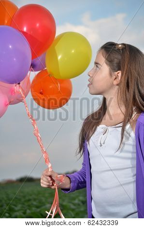 A Teenage Girl In Purple With Colorful Balloons
