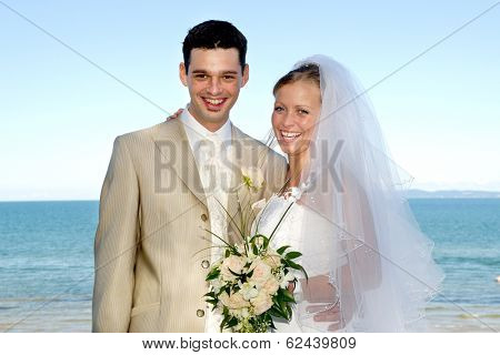 Happe wedding couple are smiling and looking 